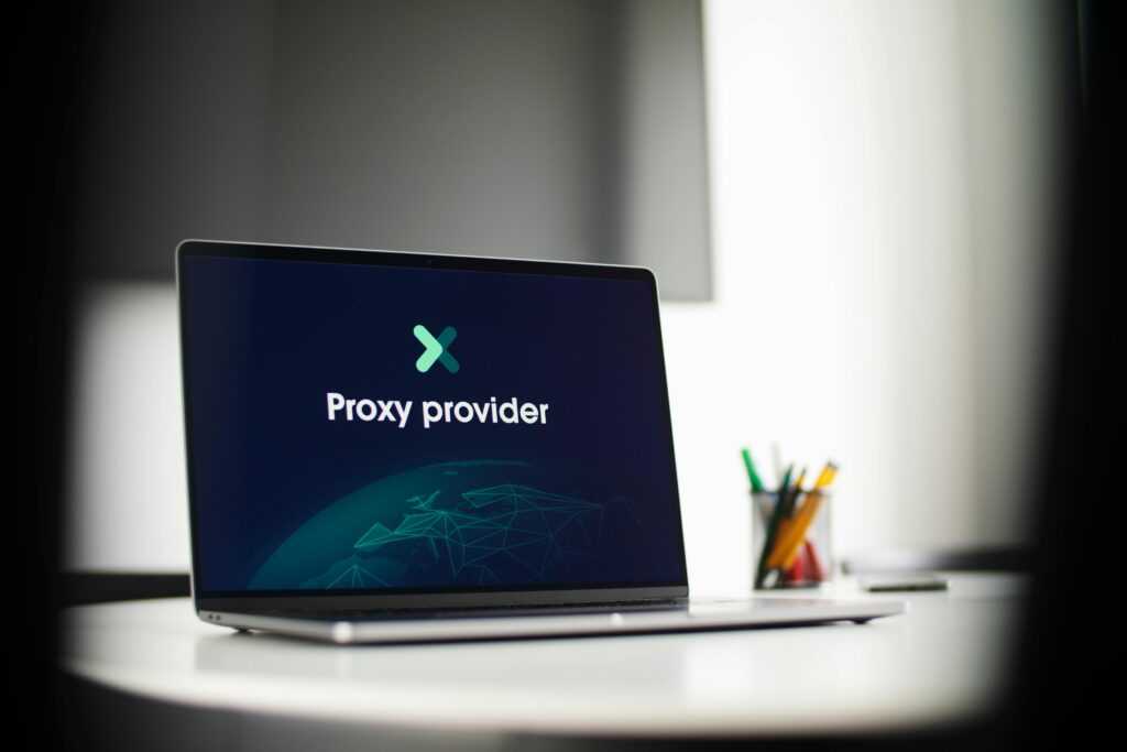 Laptop screen showing 'Proxy provider' in a tech office setting, focus on cybersecurity.